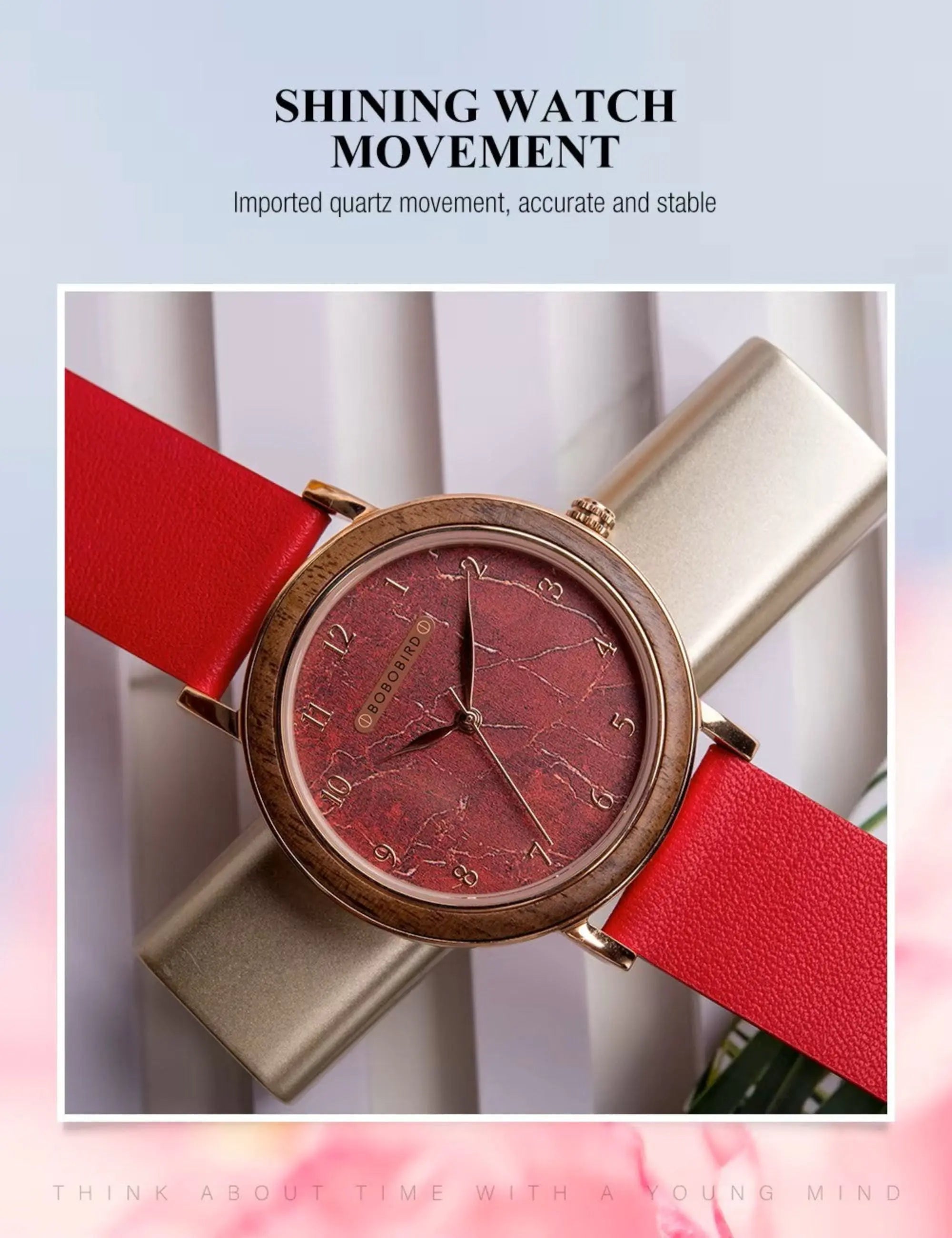 Watch with red strap and gold case on a light background