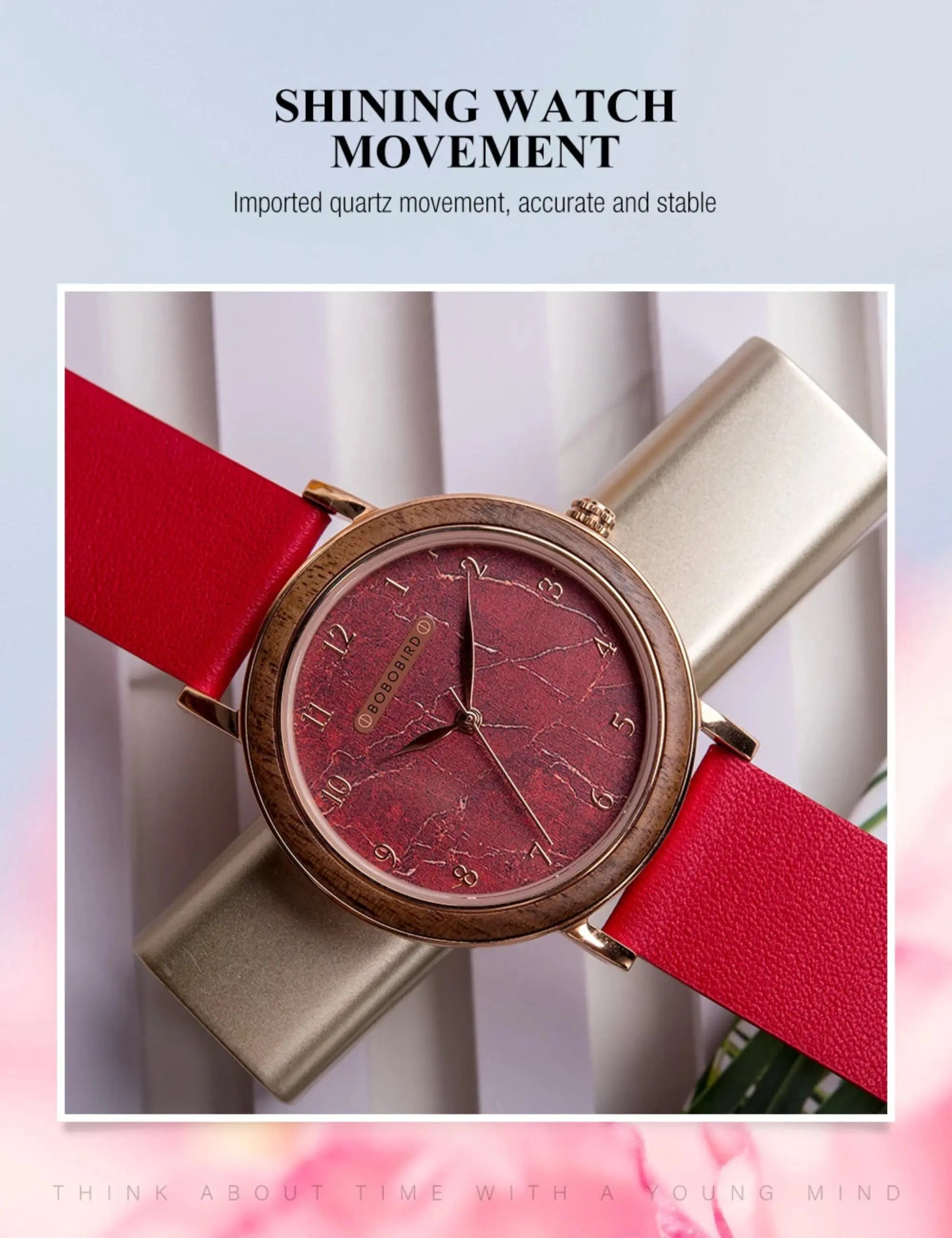 Watch with red strap and gold case on a light background