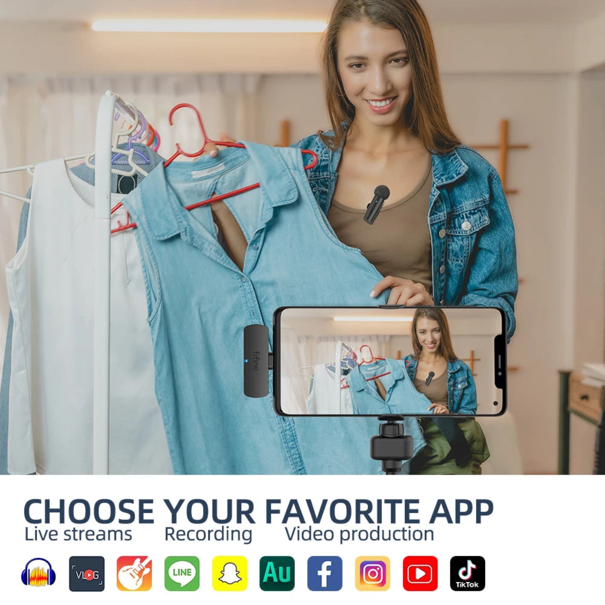 Woman holding a denim jacket with a smartphone showing a video call, surrounded by clothing on hangers.