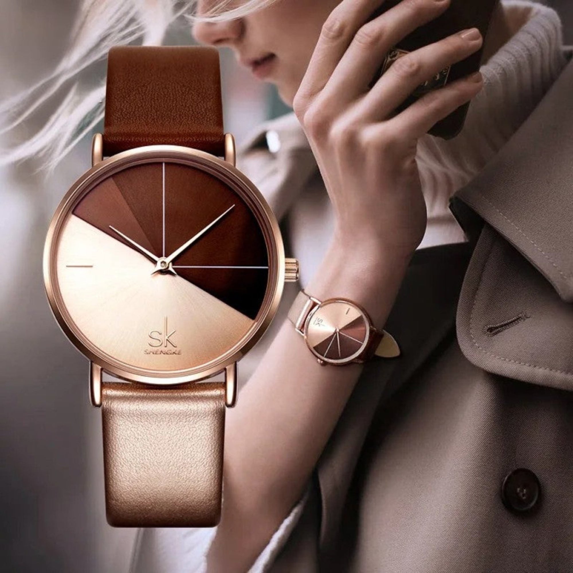 A woman wearing a Shengke quartz wristwatch with a rose gold case and a brown leather strap.