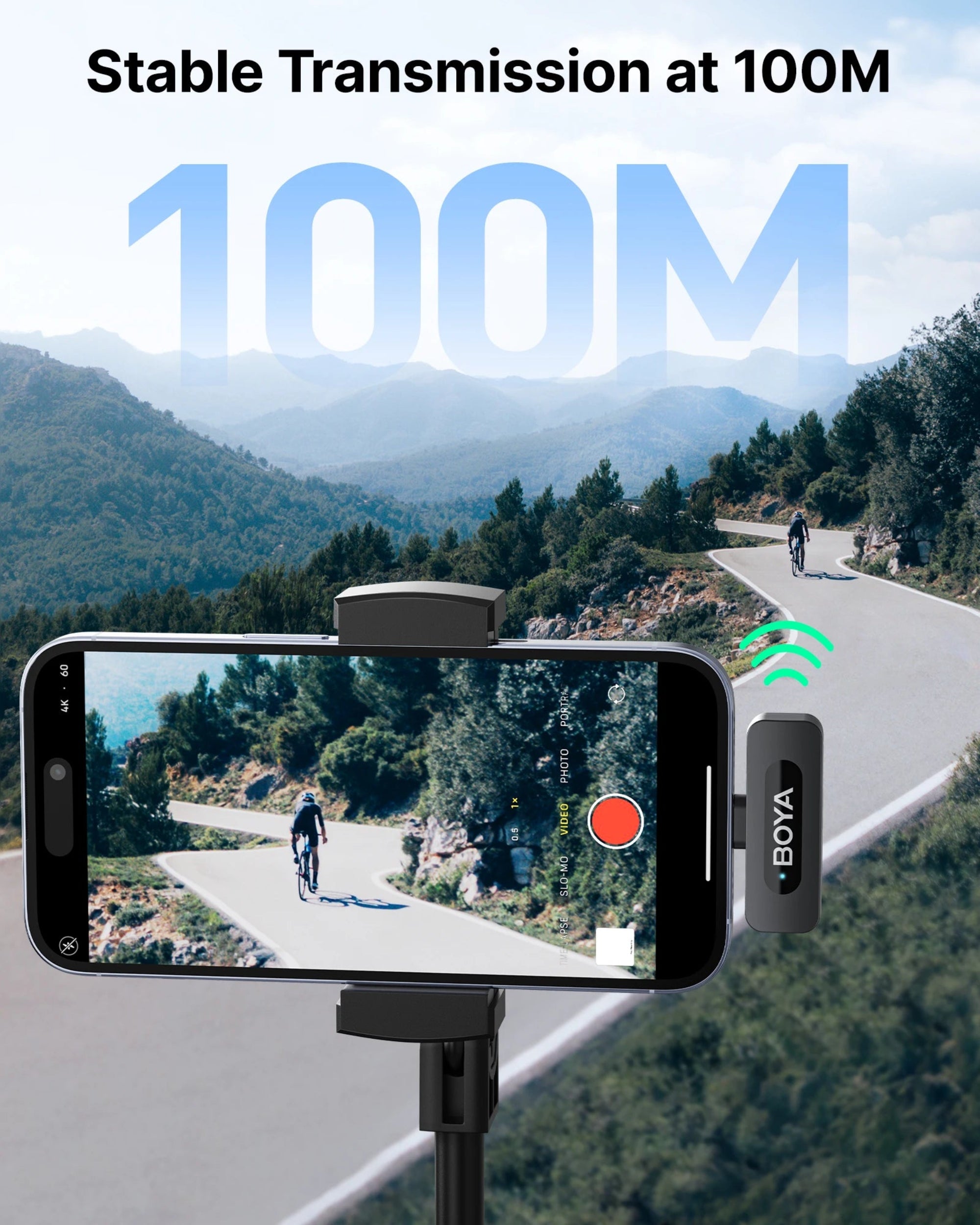 Smartphone with video recording app on screen, mounted on a stand with 'BOYA' brand, showing a scenic road with a cyclist in the background.