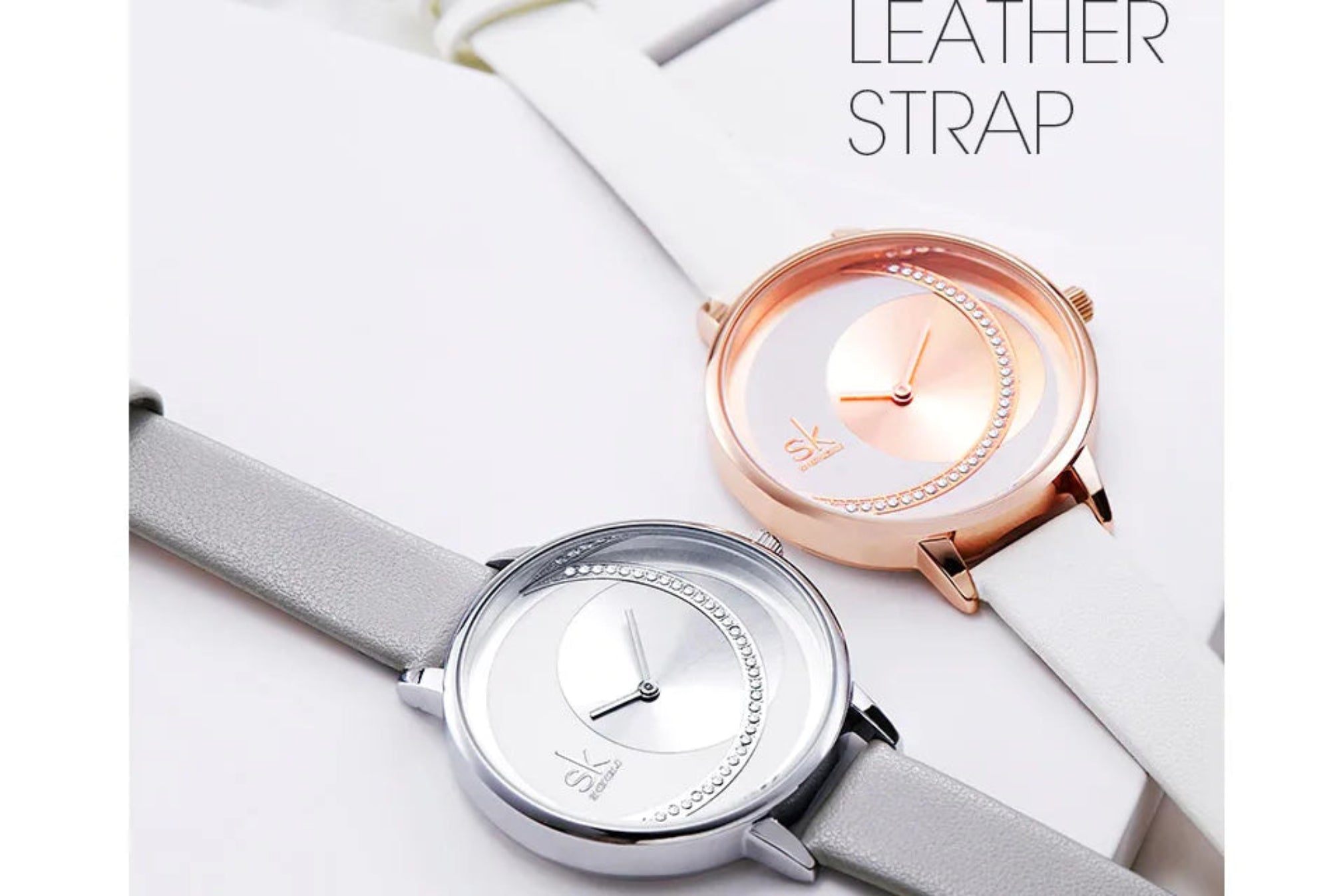 Two watches with leather straps on a white surface