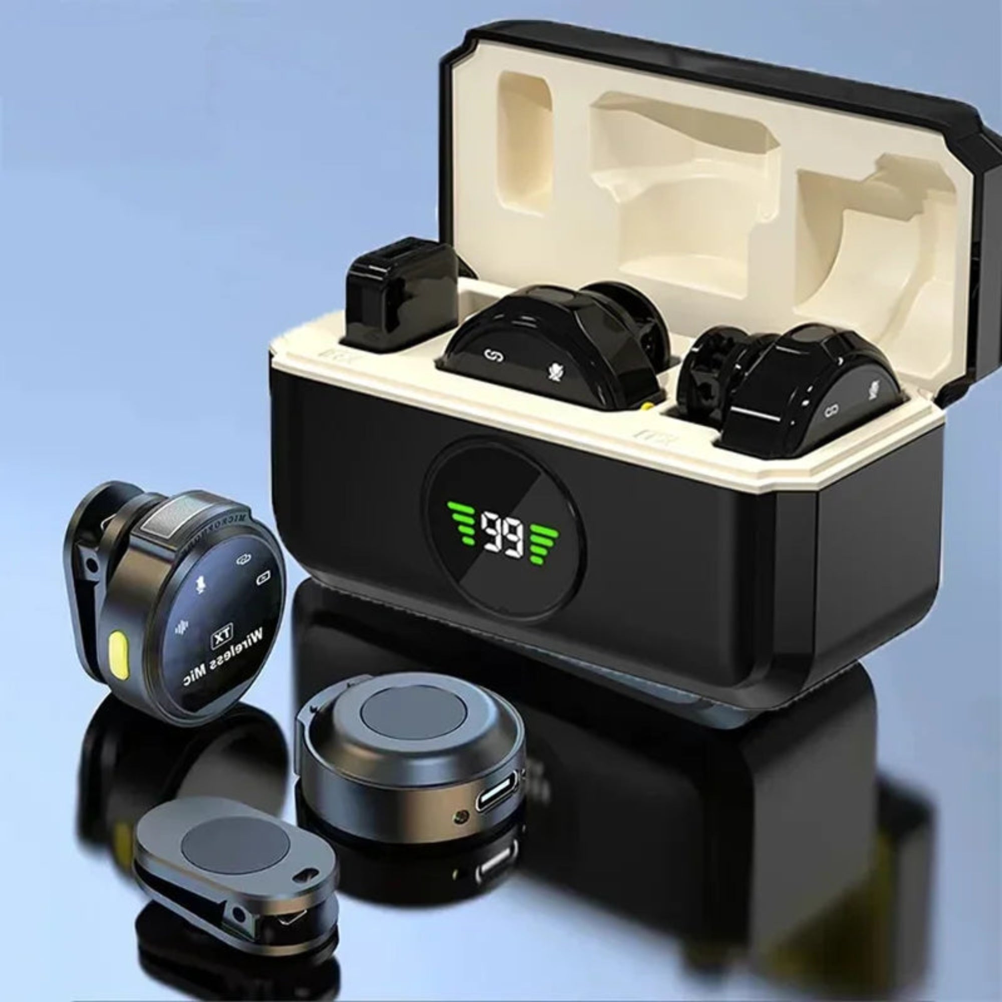 A wireless lavalier microphone set open with multiple components, including the microphone, charging case, and additional magnetic clips, displayed on a reflective surface.