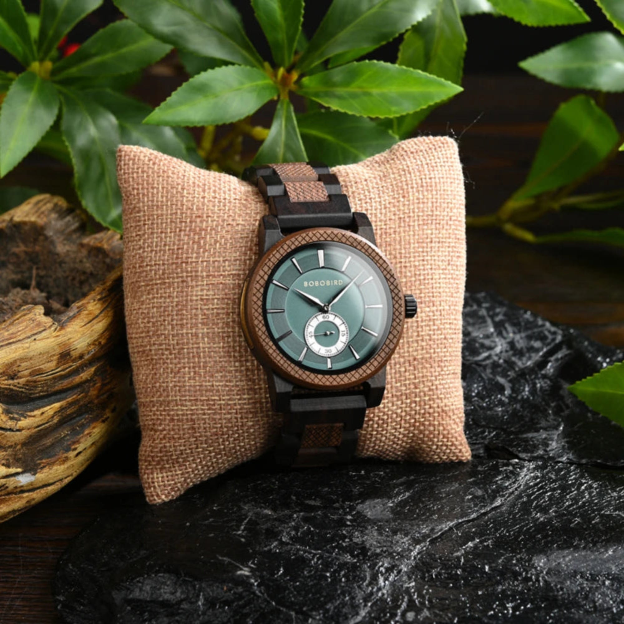Wooden watch with brown strap on a textured pillow against a natural background