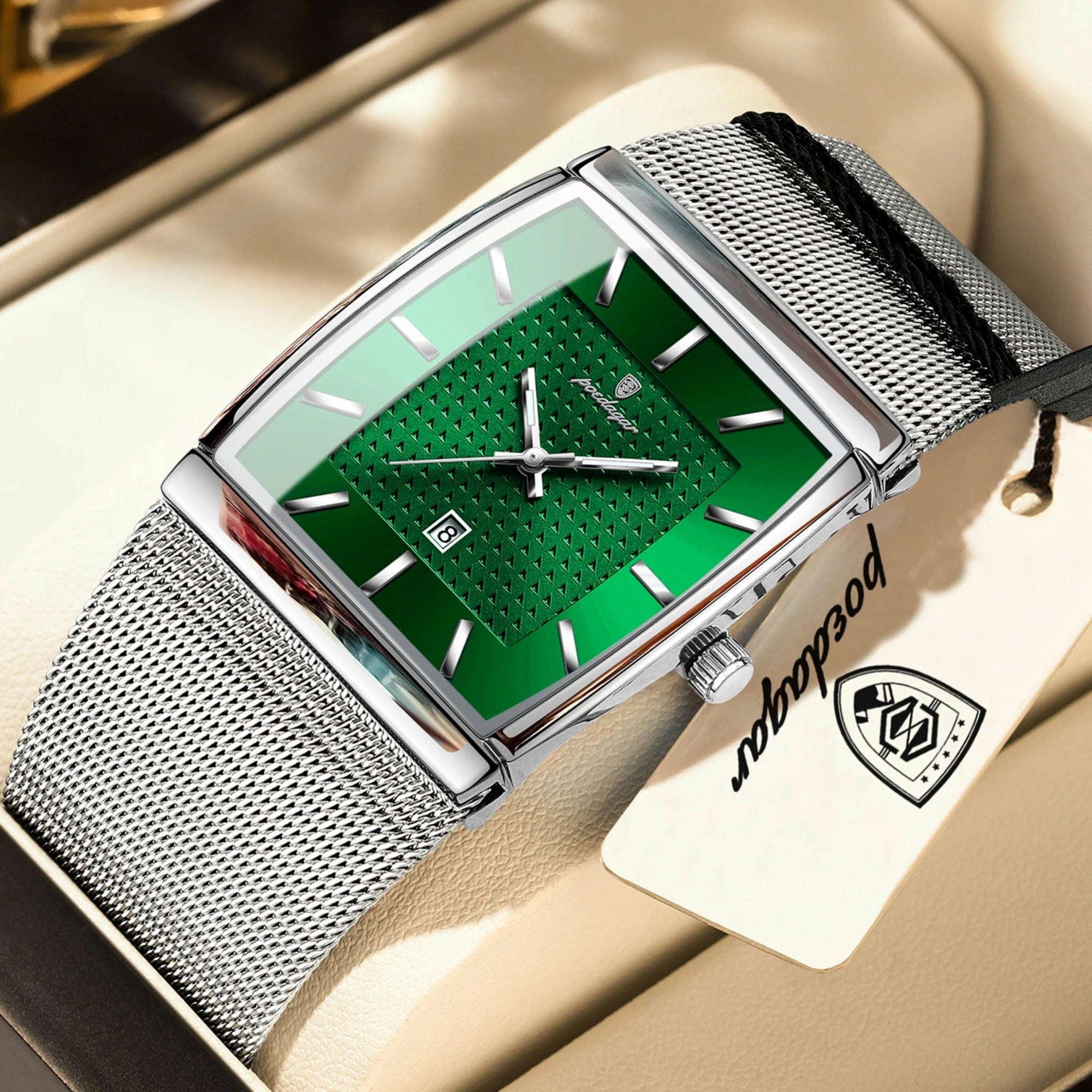 Watch with green face and silver mesh strap on a beige surface, brand name visible