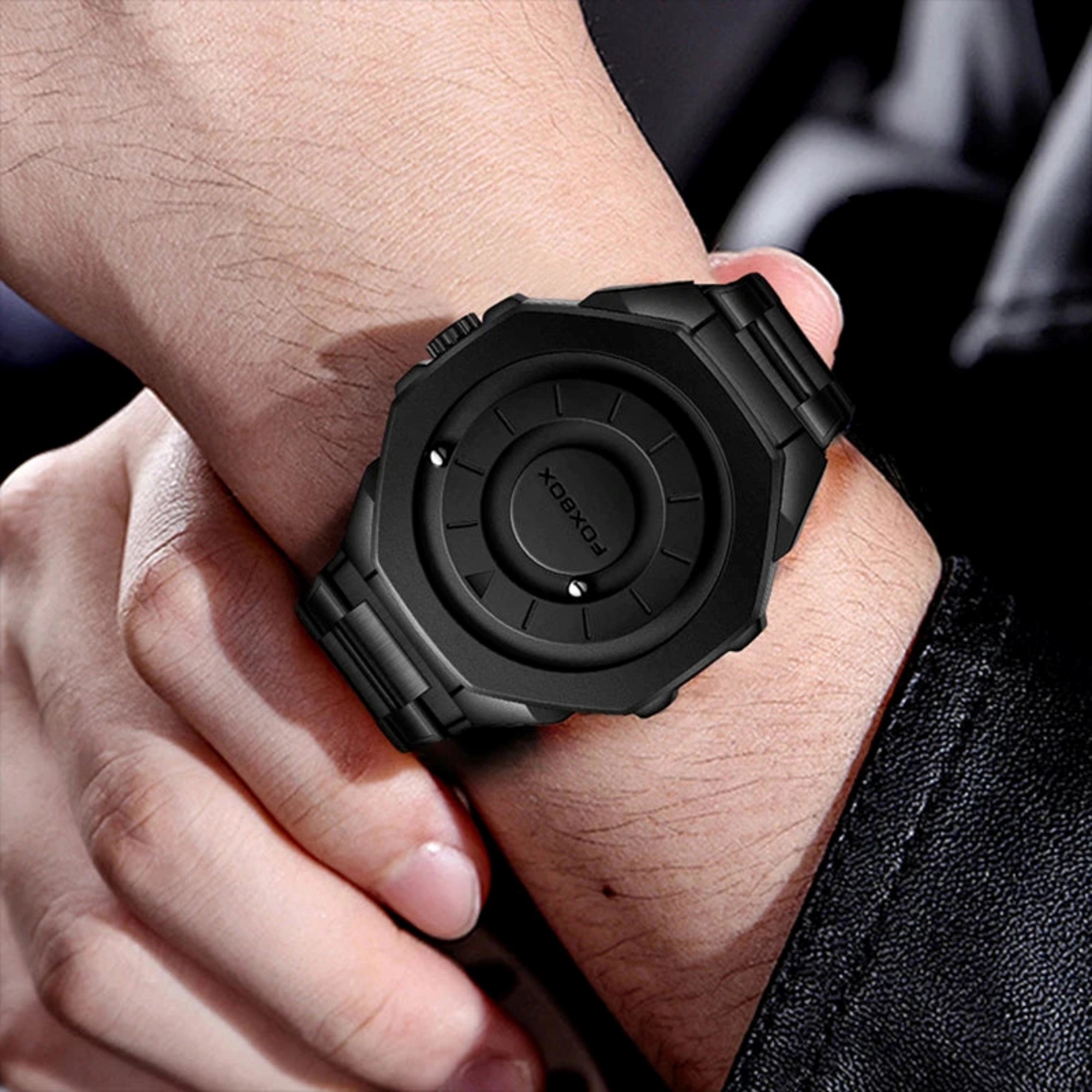 Black watch on a wrist with a blurred background