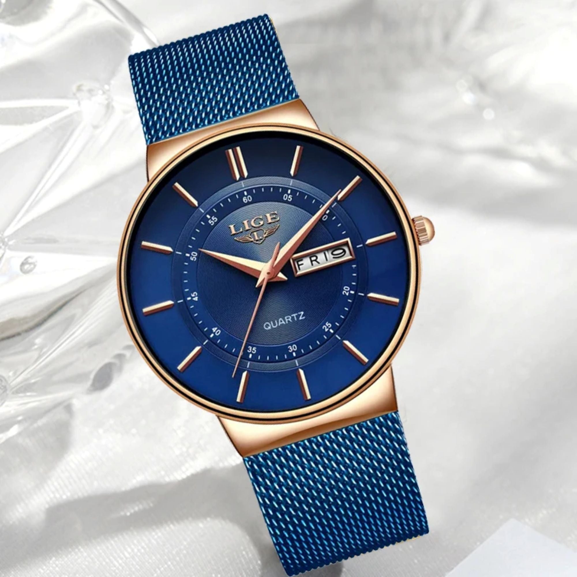 Blue watch with gold accents on a white background