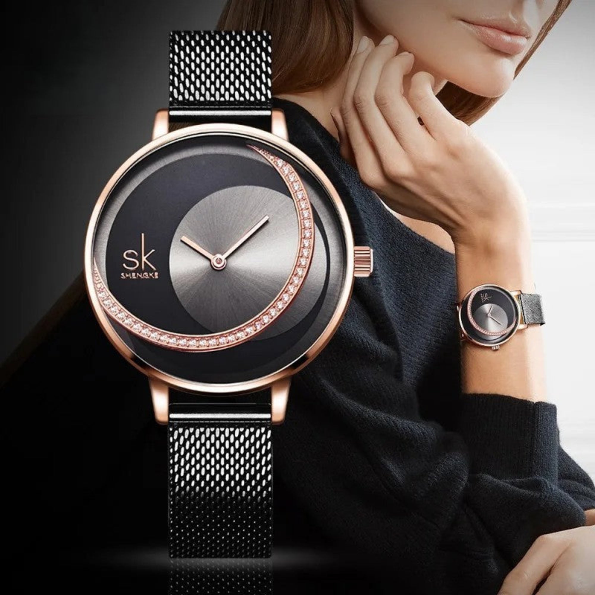 A woman wearing a Shengke brand analog watch with a rose gold case and a black mesh band.