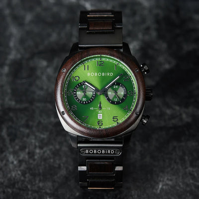 Green watch with wooden accents on a dark textured background