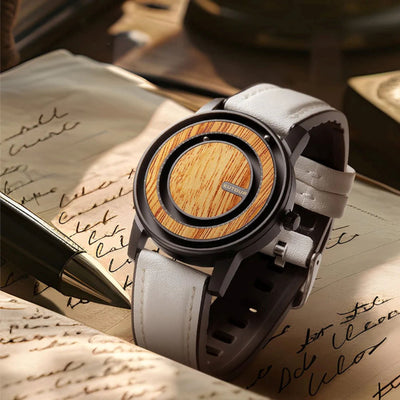 Wooden watch with gray strap on top of a handwritten letter