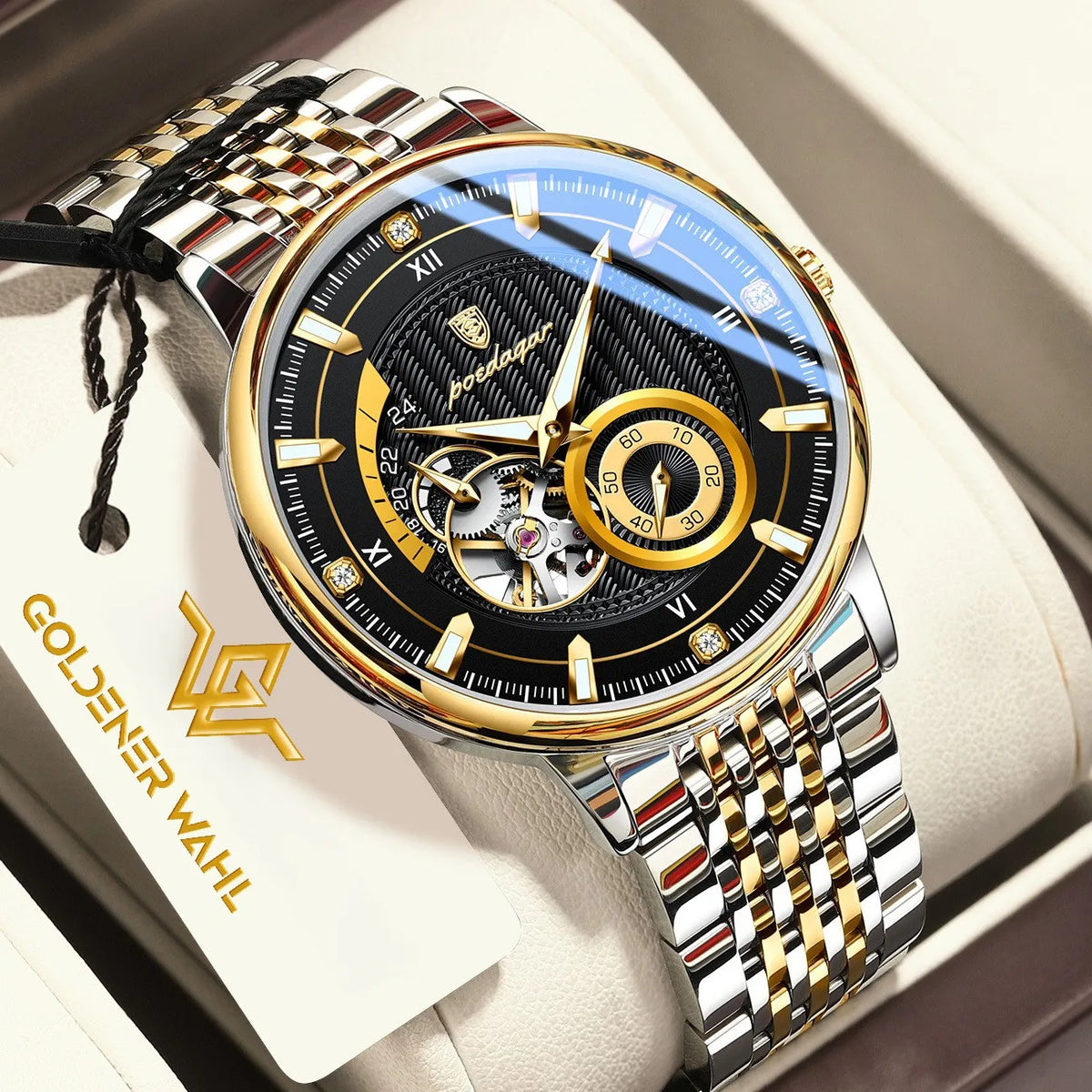 Gold and silver automatic mechanical watch with a black dial, presented in a light beige box with a branded tag.