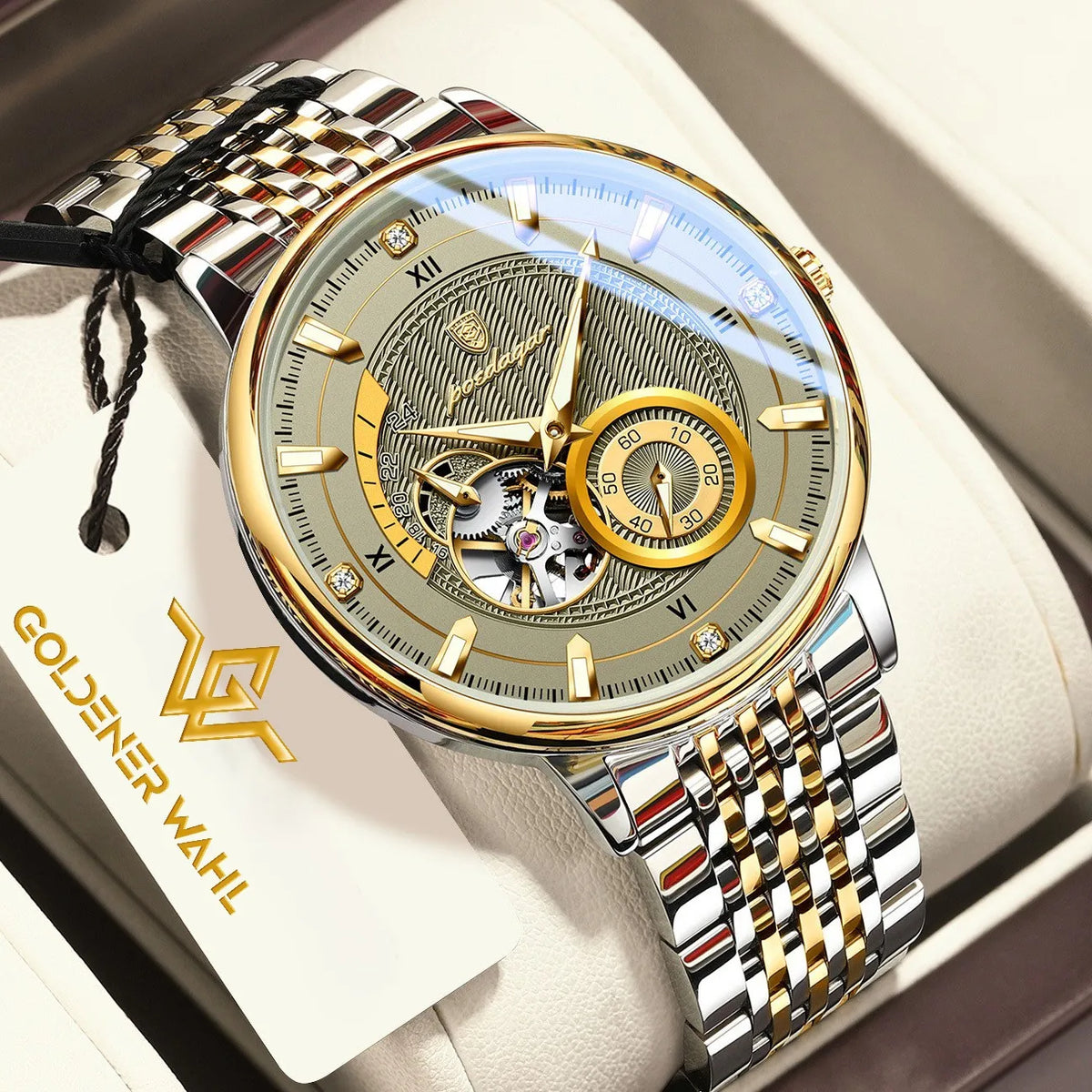 A luxury men's skeleton watch by Goldener Wahl, featuring a two-tone silver and gold stainless steel link bracelet, a gold-tone case, and a detailed skeleton dial with a gold sub-dial, presented in a cream-colored box with its brand tag visible.