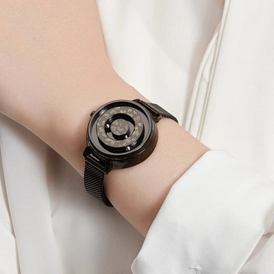 Black wristwatch on a person's wrist with a white background