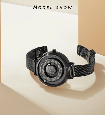 Black watch with mesh band on a beige background