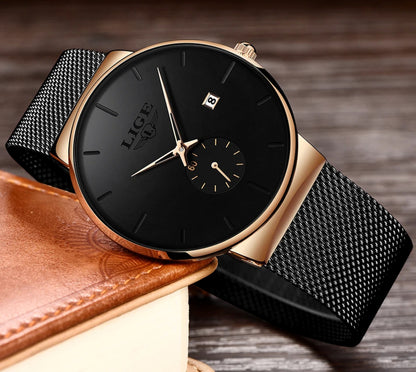 Black watch with gold accents on a wooden surface