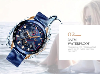 Blue wristwatch with detailed face and mesh band, water splashing around it, on a white background.