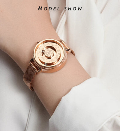 Rose gold watch on a wrist with a plain background