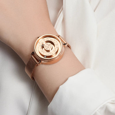 Rose gold watch on a wrist with a white background