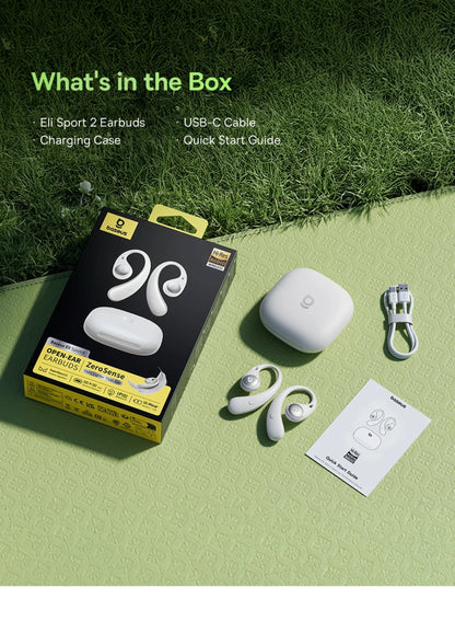 Box of earbuds with earbuds, charging case, USB-C cable, and quick start guide on a grassy background