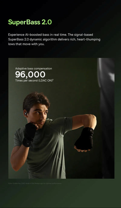 Person wearing black gloves and a gray shirt with text about SuperBass 2.0 technology.