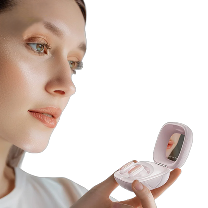 Woman holding a small, open pink case with a mirror on a white background