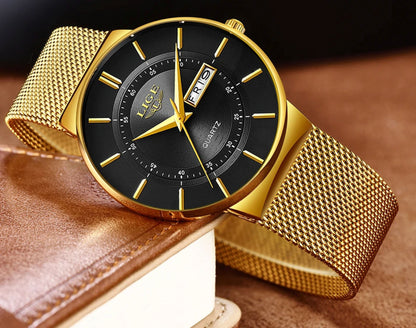 Gold watch with black face on a brown leather surface