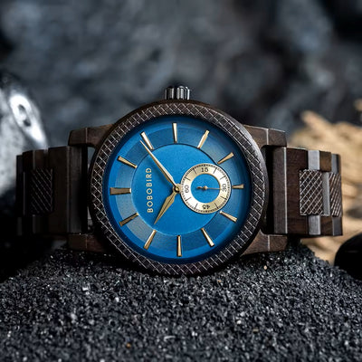 Wooden watch with blue face and gold accents on a dark surface
