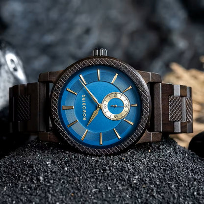Wooden watch with blue face and gold accents on a dark surface