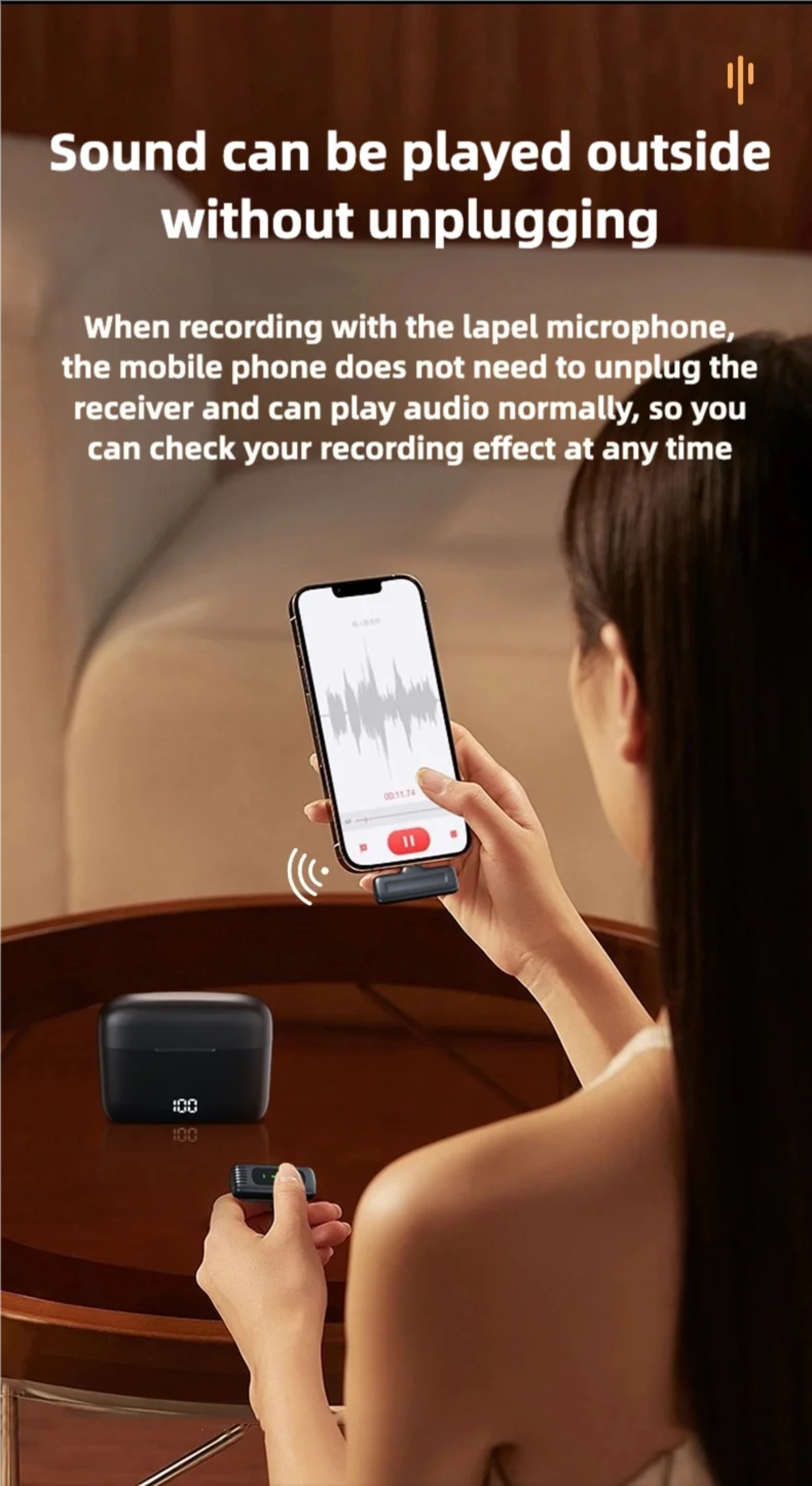 Person using a smartphone with a recording app and a lapel microphone on a table.