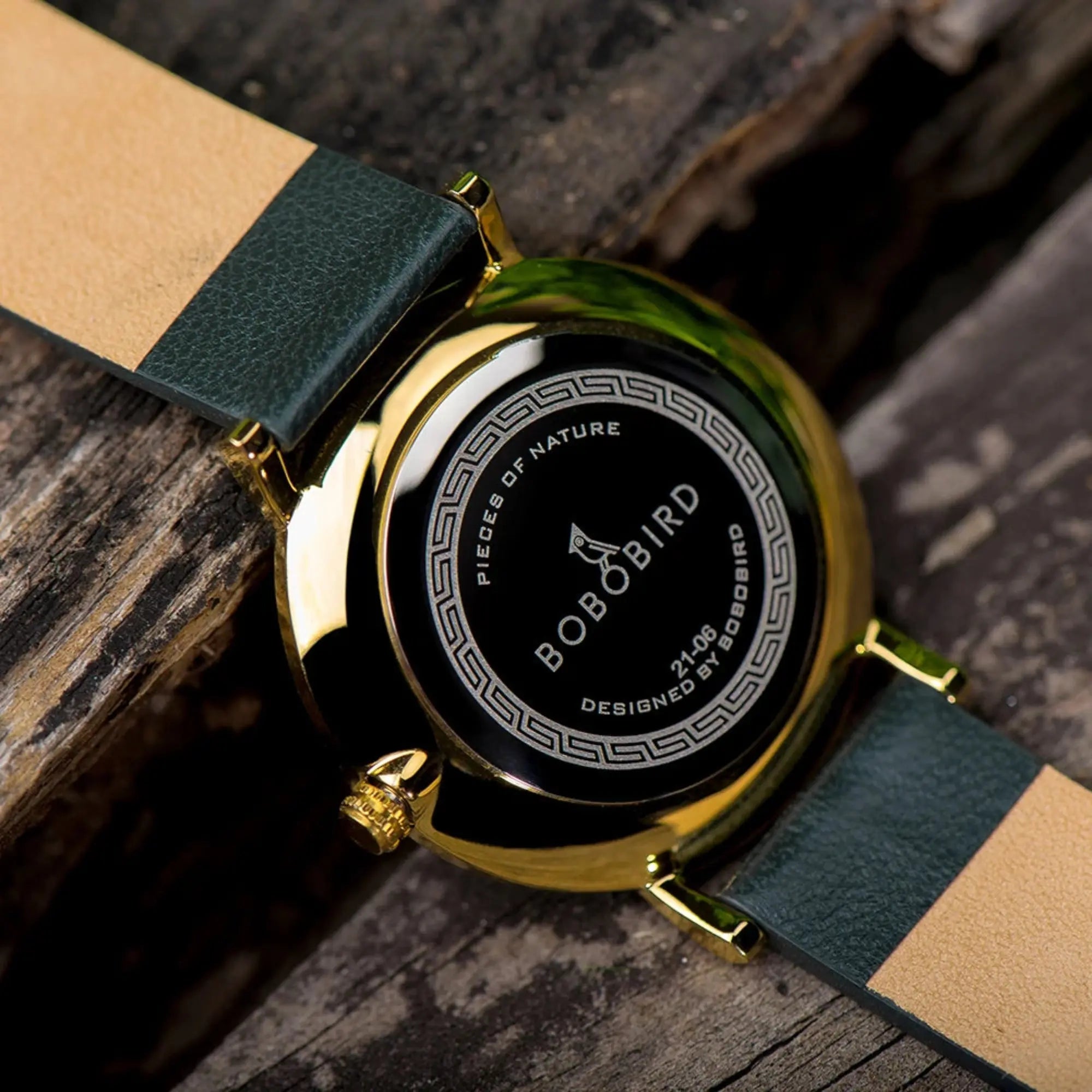 Watch with green and beige strap on a wooden surface, featuring Bobo Bird branding.