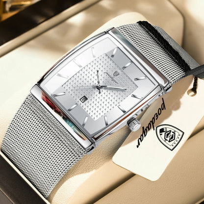 Silver watch with mesh band on a beige surface, brand tag visible