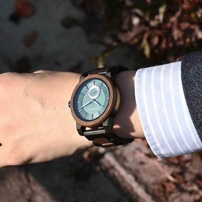 Person wearing a smartwatch with a nature background