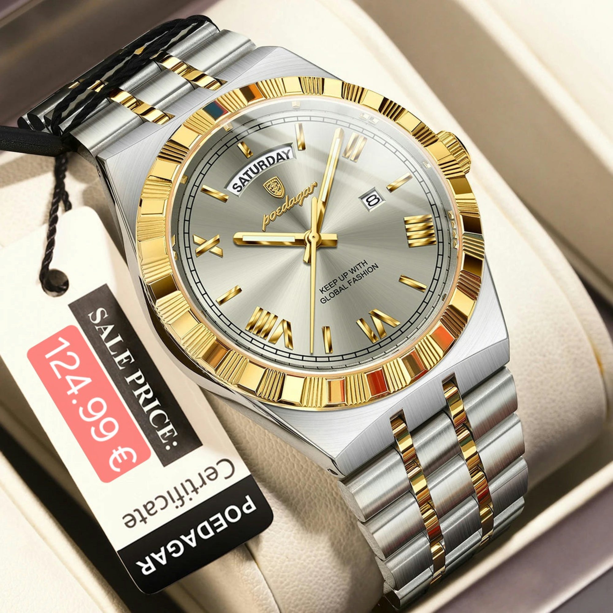Silver and gold watch with a price tag on a beige cushion