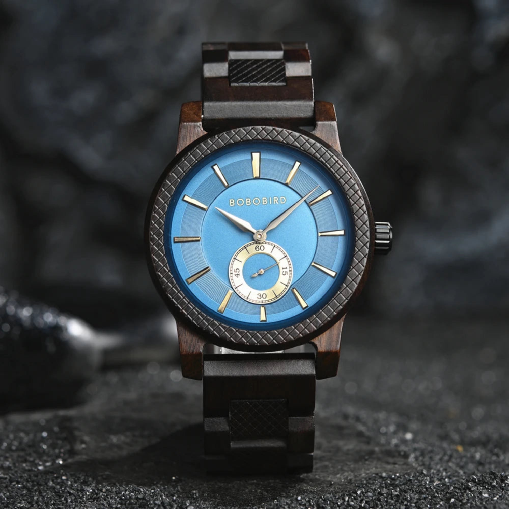 A watch with a green dial and wooden strap, featuring a patterned bezel and analog hands.