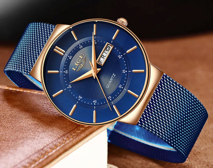 Blue watch with gold accents on a brown leather surface