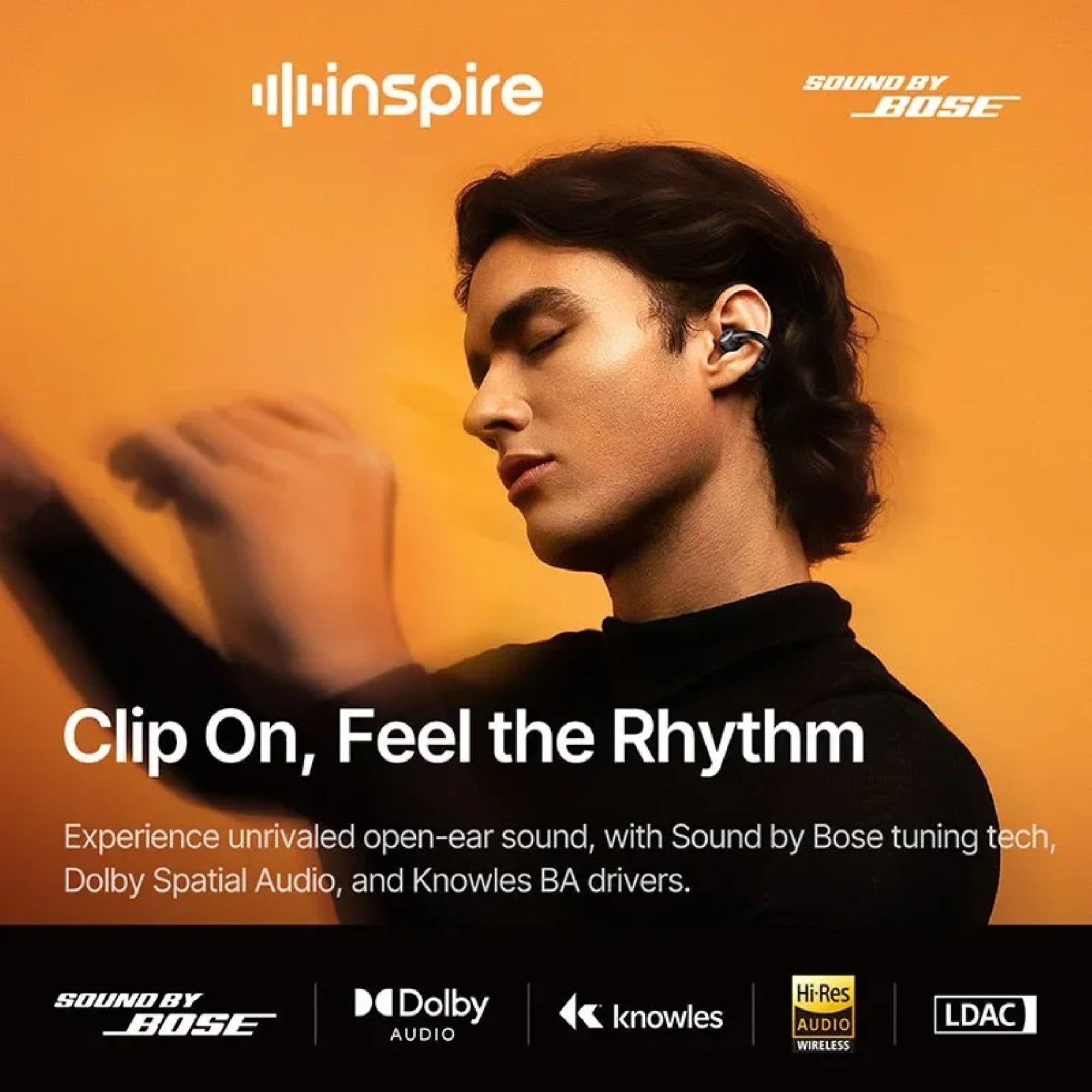 Person wearing wireless earbuds with 'inspire' branding and Bose logo on an orange background