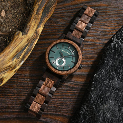 Wooden watch with a green face on a dark wooden surface
