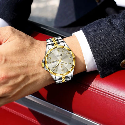 A two-tone stainless steel and gold watch with a silver dial, worn on a person's wrist. The watch features a gold-tone bezel, gold hands, and a silver-tone link bracelet.