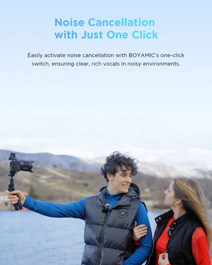 Person holding a camera with BOYAMIC noise cancellation feature, scenic background