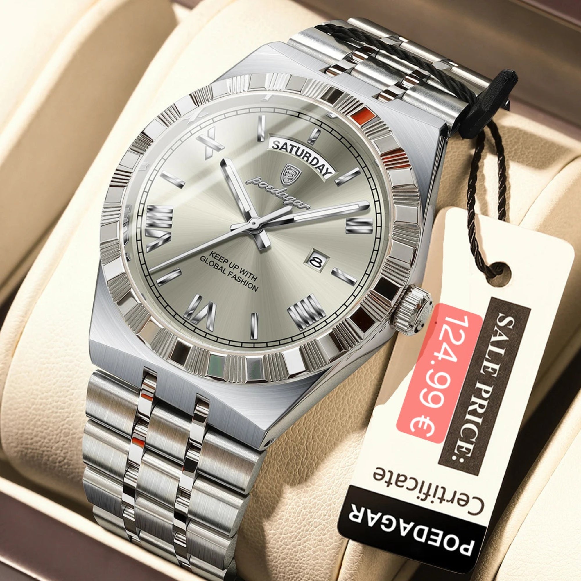 Silver watch with a visible brand tag on a beige surface