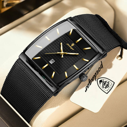 Black wristwatch with gold accents on a beige surface, featuring a brand tag.