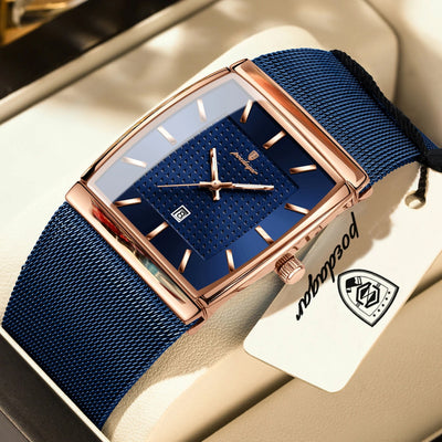 Luxury watch with blue strap and rose gold case on a beige surface, featuring a brand tag.