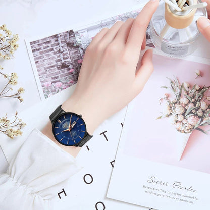 Hand wearing a watch with a decorative background featuring flowers and cards