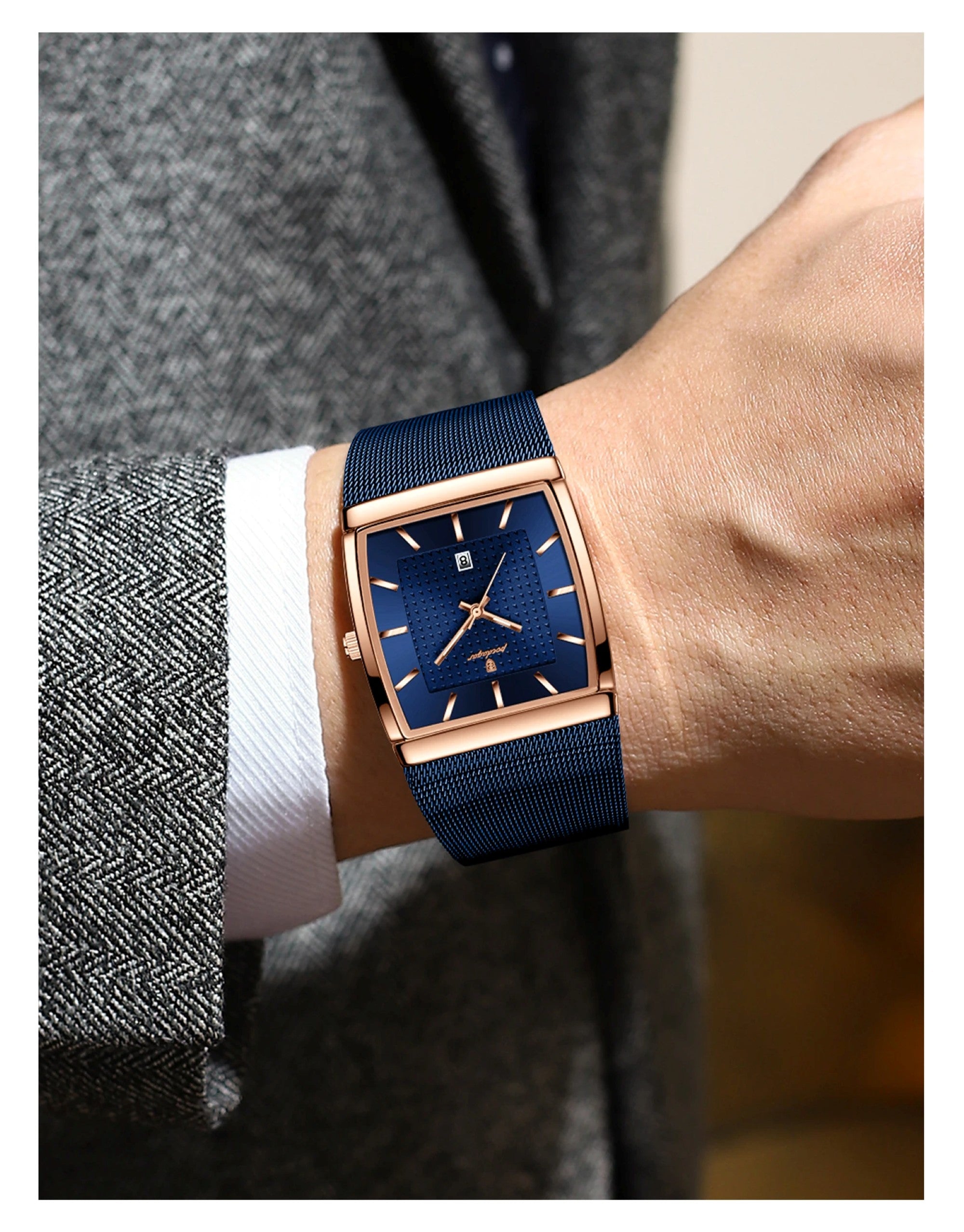 Wrist wearing a blue watch with rose gold case on a blurred background