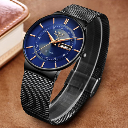Luxury watch with blue dial and black mesh strap on a brown background