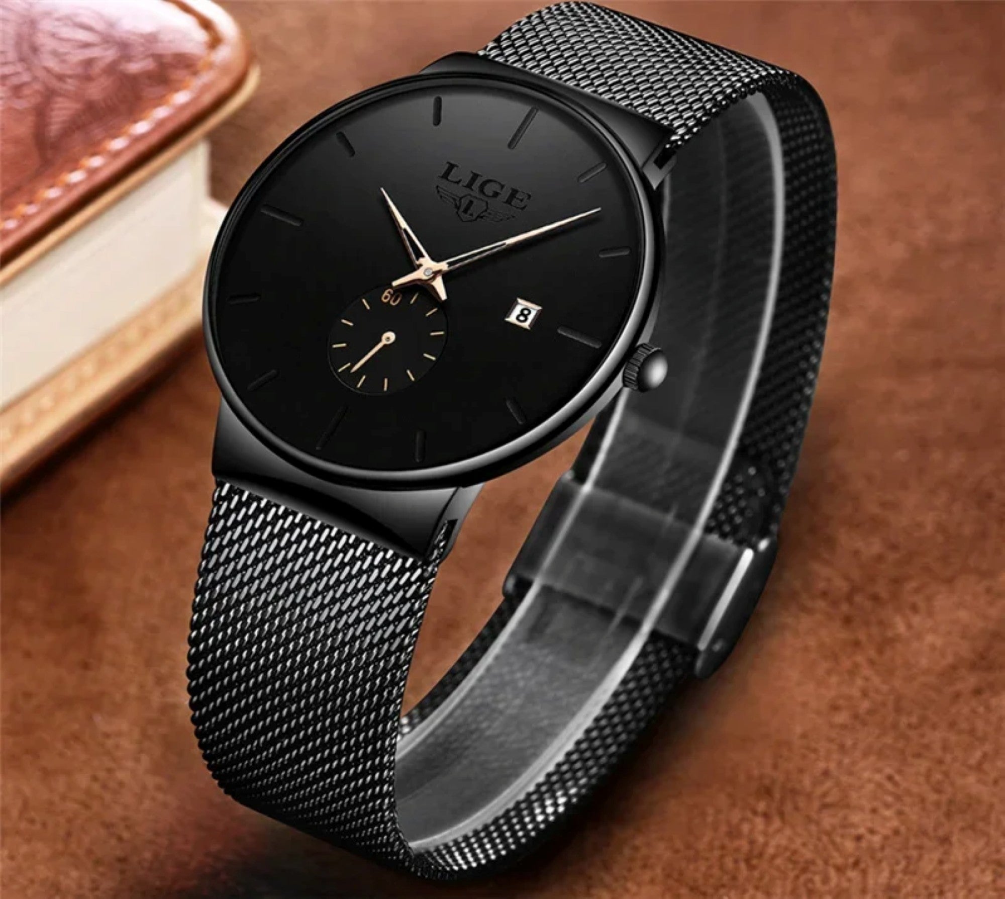 Black wristwatch with mesh band on a brown background