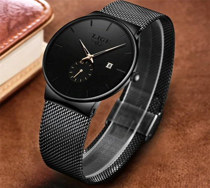 Black wristwatch with mesh band on a brown background