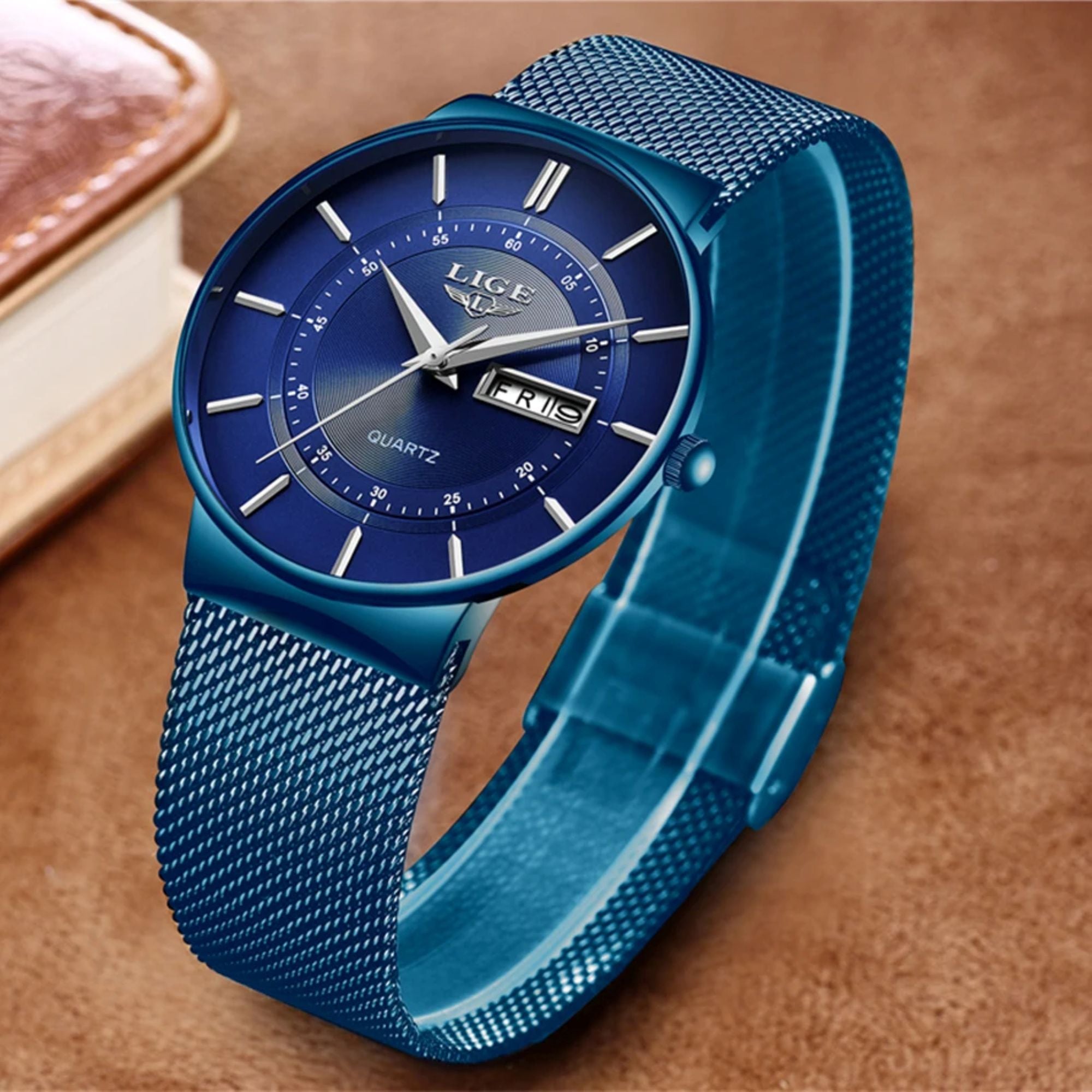 Blue wristwatch with mesh band on a brown background