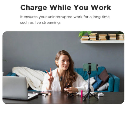 Woman sitting at a desk with a laptop and phone, with text about charging while working.