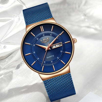 Blue watch with gold accents on a white background